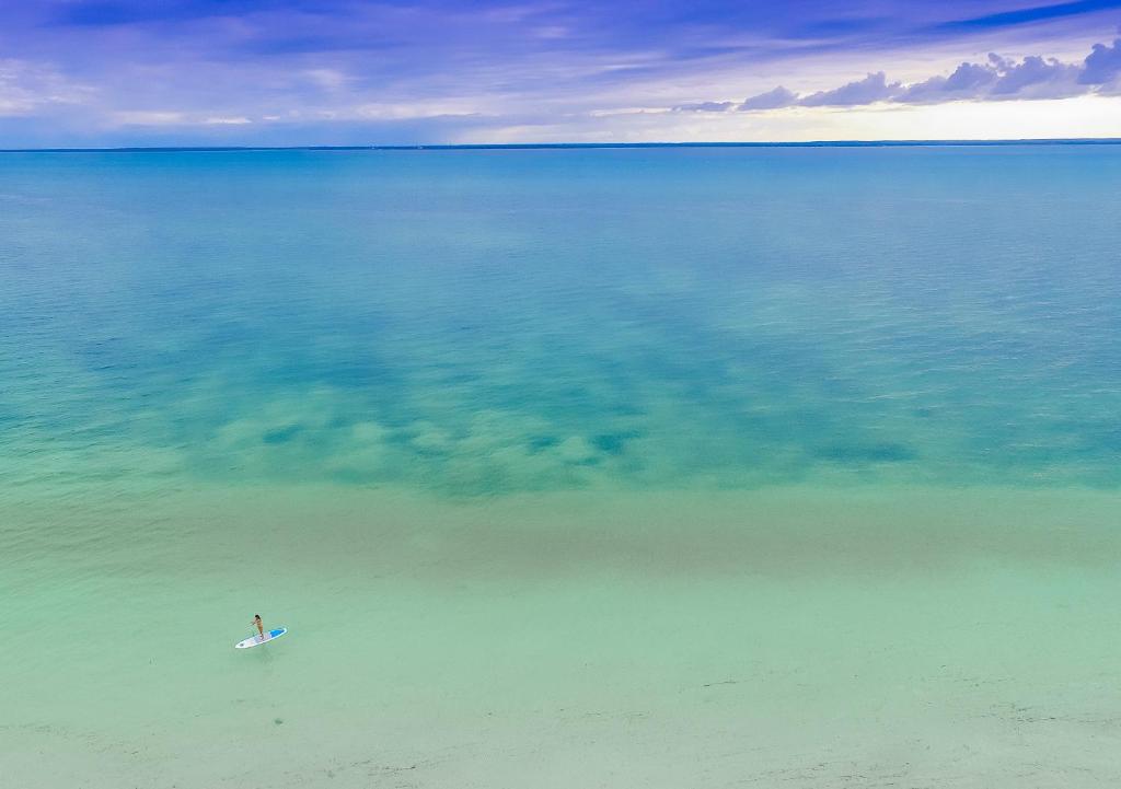 Konokono Beach Resort, stand-up paddleboarding azure seas
