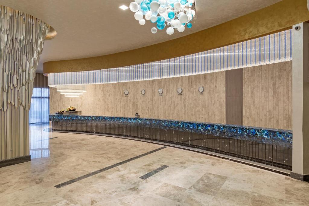 Elegant reception area at Royal Seginus with modern decor and artistic lighting.