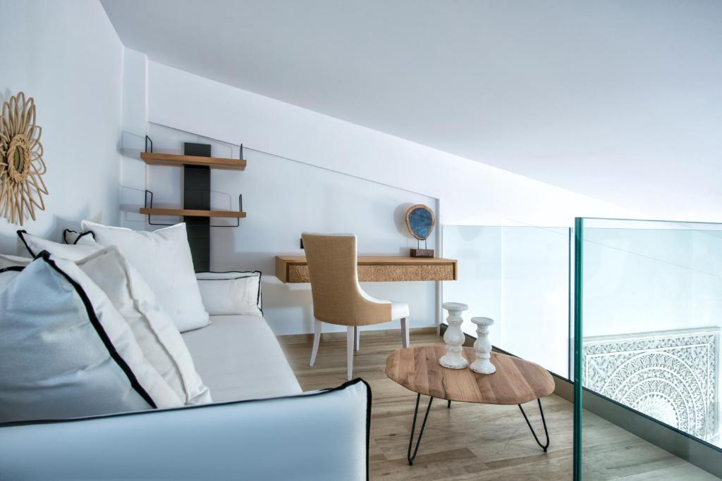 Eleganta atpūtas zona Abaton Island Resort & Spa ar dīvānu un rakstāmgaldu.