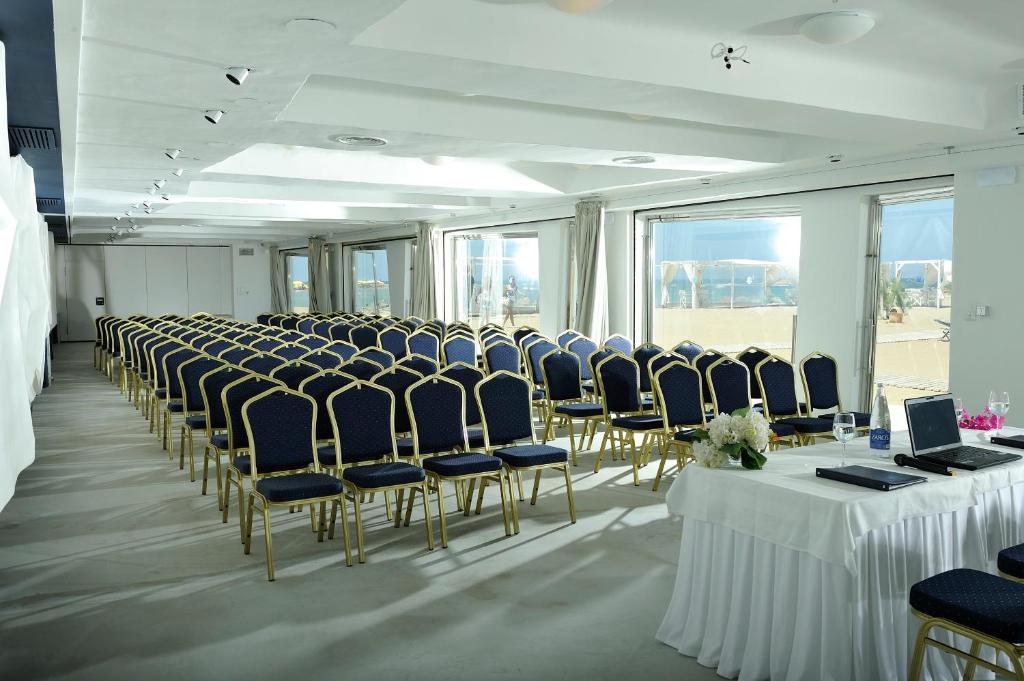 Konferenču zāle ar ziliem krēsliem viesnīcā Knossos Beach Bungalows Resort