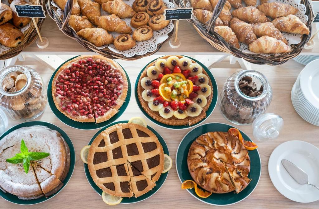 Bakery display featuring an assortment of delicious pastries, cakes, and tarts, including fruit tarts and a chocolate pie, perfect for a sweet indulgence.