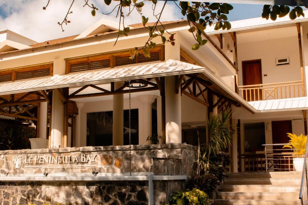 Viesnīcas "Le Peninsula Bay" ēka ar elegantu arhitektūru un dārza elementiem. Ideāla vieta atpūtai pie jūras.
