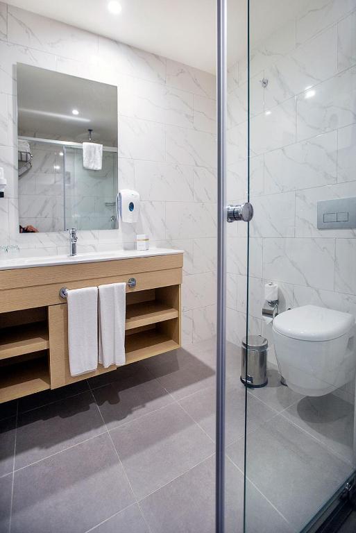 Moderns vannas istabas interjers Numa Bay Exclusive Hotel ar stikla dušu.