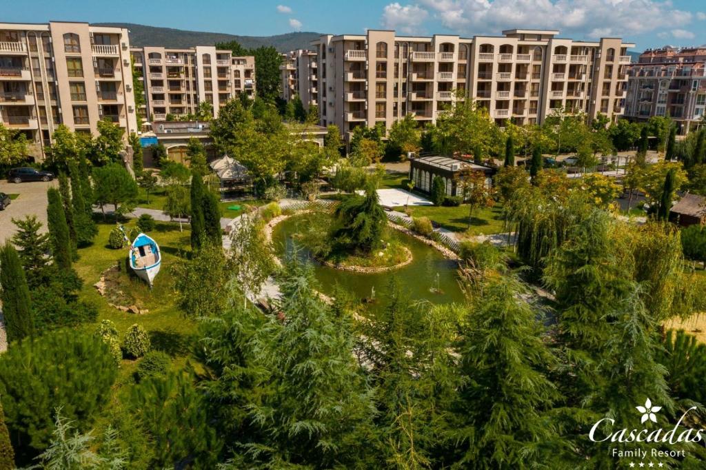 Dabas ainava ar dārzu un ūdenskrātuvi, ko ieskauj daudzdzīvokļu ēkas, ideāla vieta atpūtai un atpūtas iespēju baudīšanai.