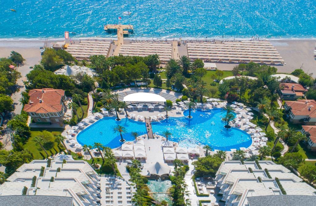 Aerial view of Rai Premium Tekirova's stunning pool area by the beach.