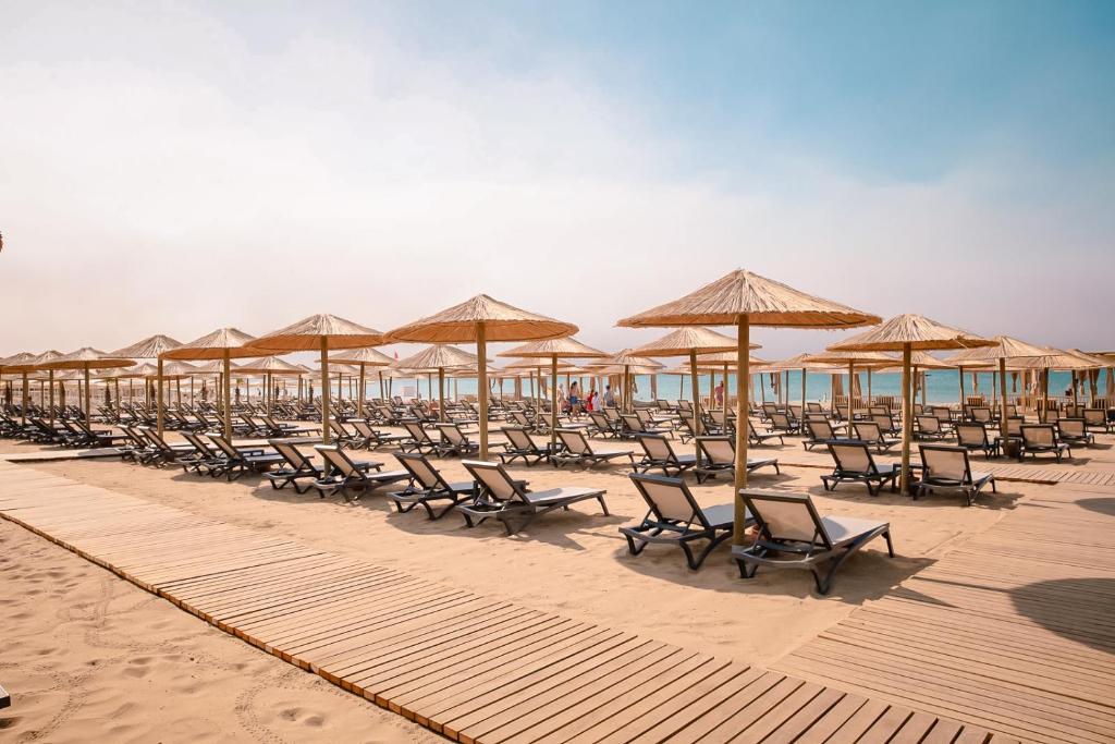 Piekraste ar saulessargiem un atpūtas krēslām pie LIU Resorts