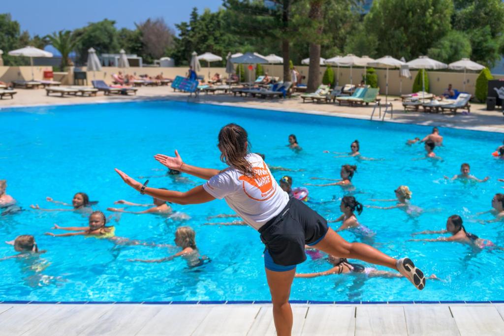 Aqua aerobics class at Sun Beach Resort pool with lively participants.