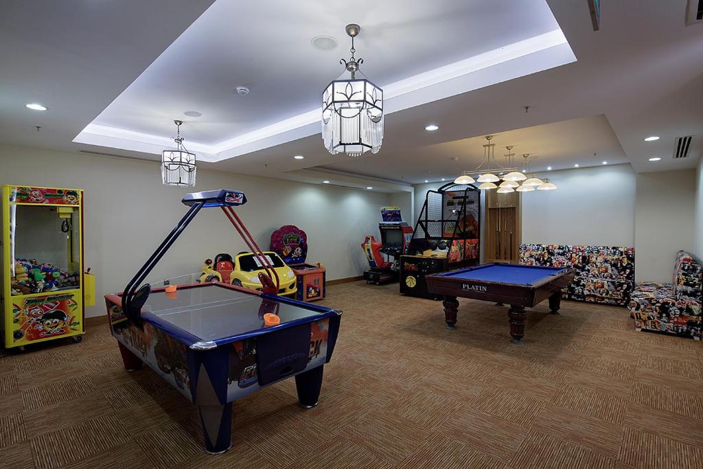 Bērnu izklaides telpa Alba Resort Hotel ar spēļu automātiem un biljarda galdu.