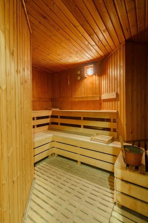 Koka saunas interjers ar koka sienām un soliem, radot relaksējošu atmosfēru. Saunā redzama arī neliela koka spainis un lāpstiņa.