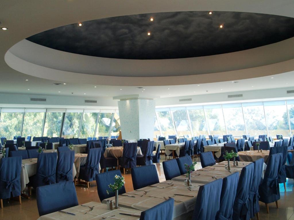 Kalypso Beach restorāns ar elegantiem galdiem un skatu uz dabu