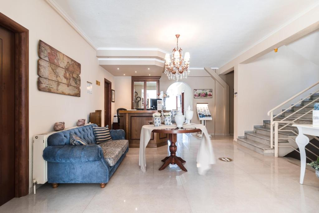 Mūsdienīgs un elegants viesnīcas vestibils ar zilo dīvānu, elegantām mēbelēm un greznu lustru. Gaismas un telpas harmonija rada viesmīlīgu atmosfēru.