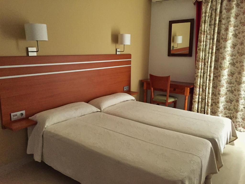 Mūsdienīgs viesnīcas numurs ar divām atsevišķām gultām, koka galdu un krēslu, kā arī logu ar aizkariem. Numurā ir siltas krāsas interjers un sienas lampas.