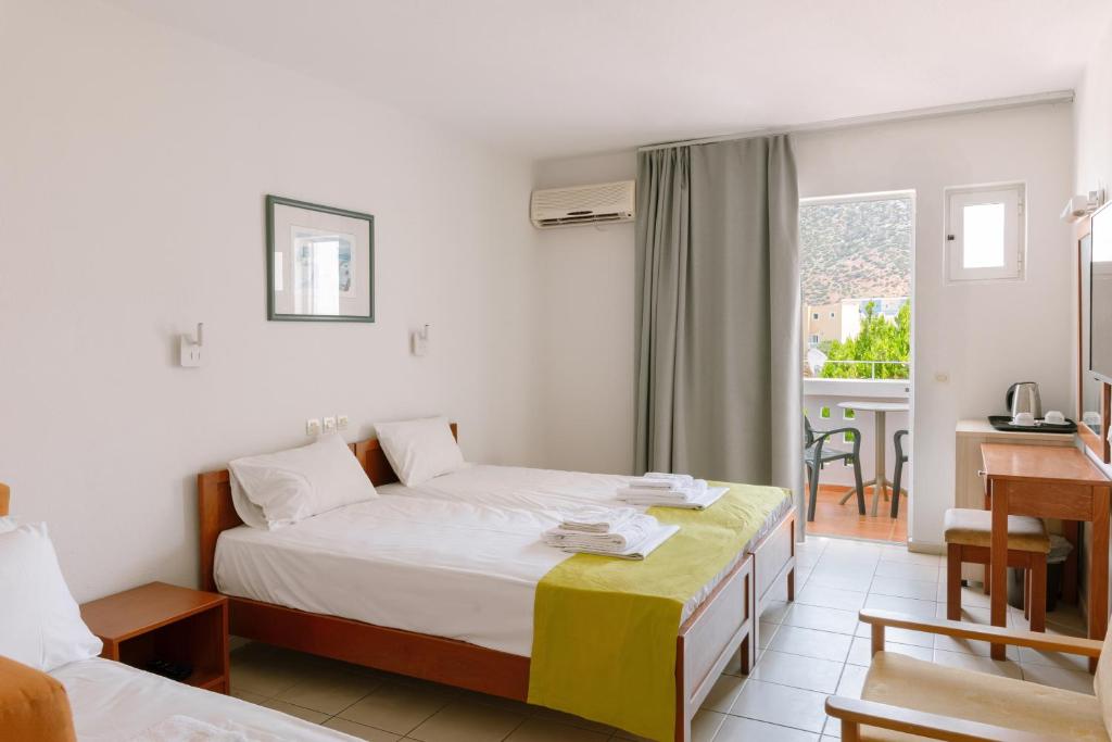Numurs pie Bali Beach Hotel ar divām gultām un balkonu.