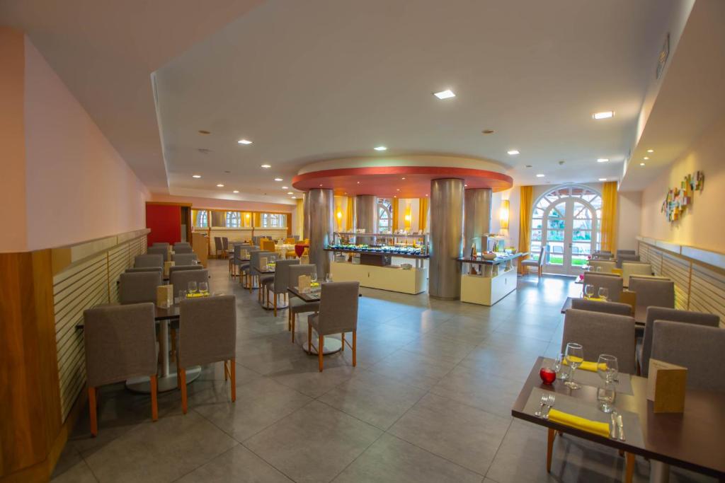 Mūsdienīgs restorāns ar ērtām ēdamzonām un plašām logiem, kas nodrošina dabisko apgaismojumu. Interjers veidots ar neitrālām krāsām un elegantiem galdiem.