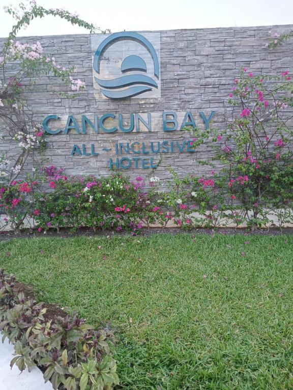 Cancun Bay all-inclusive hotel with vibrant flowers.