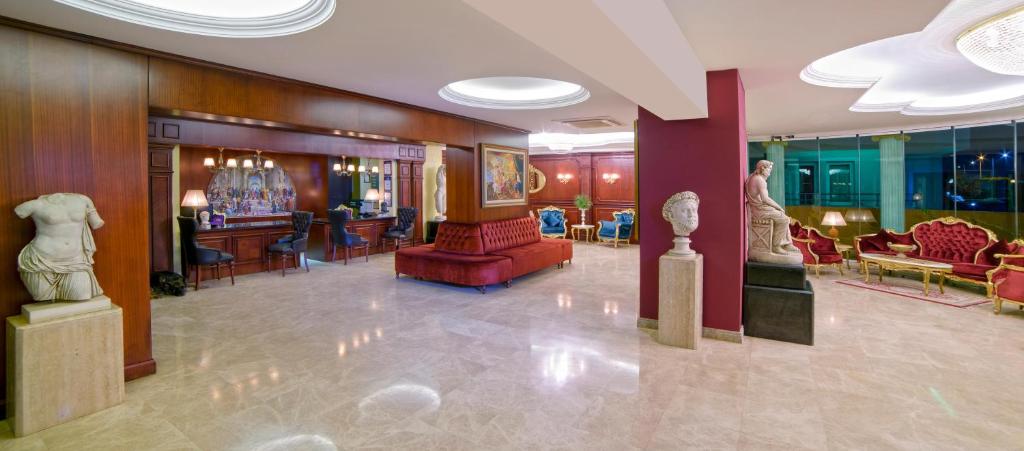 Elegant lobby at Antique Roman Palace with sculptures and plush seating.