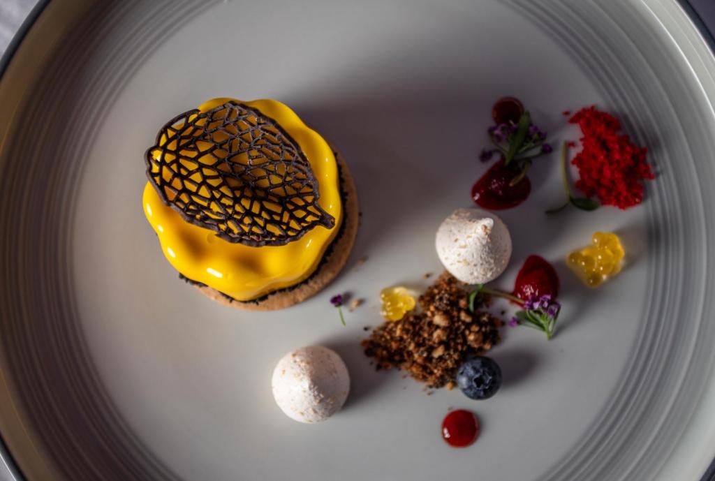 Saldējumā no Sea Diamond Boutique Hotel & Spa ir krāsains deserts ar augļu mērci.