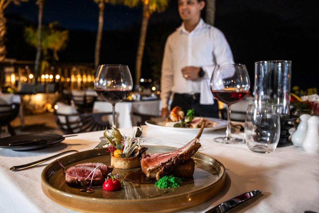 Gourmet meal served at Sea Diamond Boutique Hotel & Spa with wine.