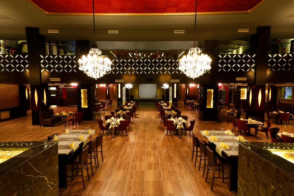 Elegant dining area at Albatros White Beach Resort with chandeliers and stylish decor.