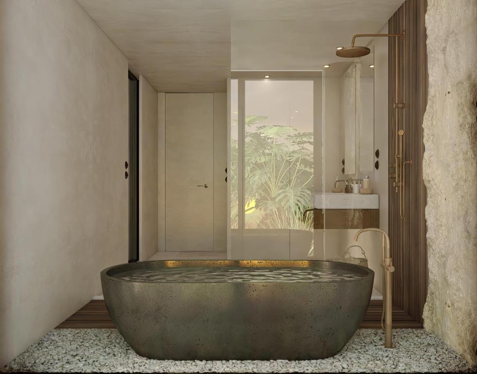 Elegants vannas istaba ar mūsdienīgu akmens vannu OKU Bodrum.