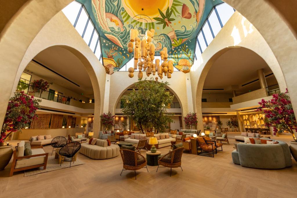Desert Rose Resort elegant lobby with vibrant ceiling art.