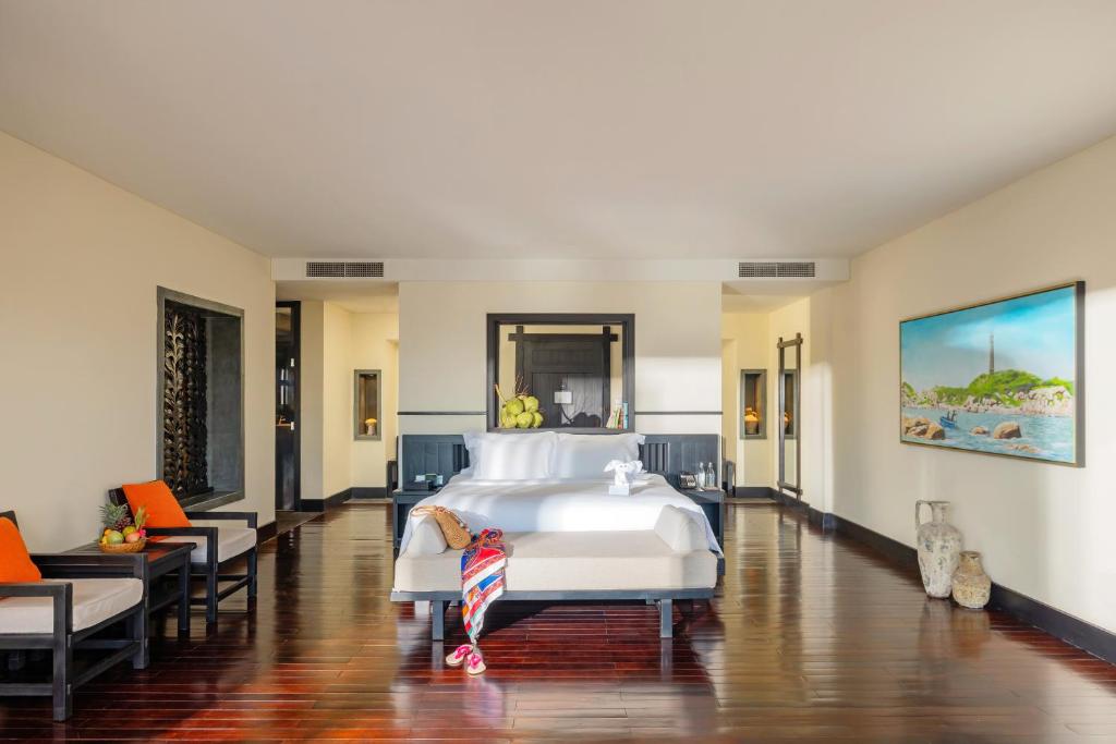 Mūsdienīga viesnīcas numura iekšskats ar plašu gultu, ērtām mēbelēm un dekoratīvu mākslu uz sienām. Numurā ir silti toņi un dabīgais apgaismojums, kas rada relaksējošu atmosfēru.