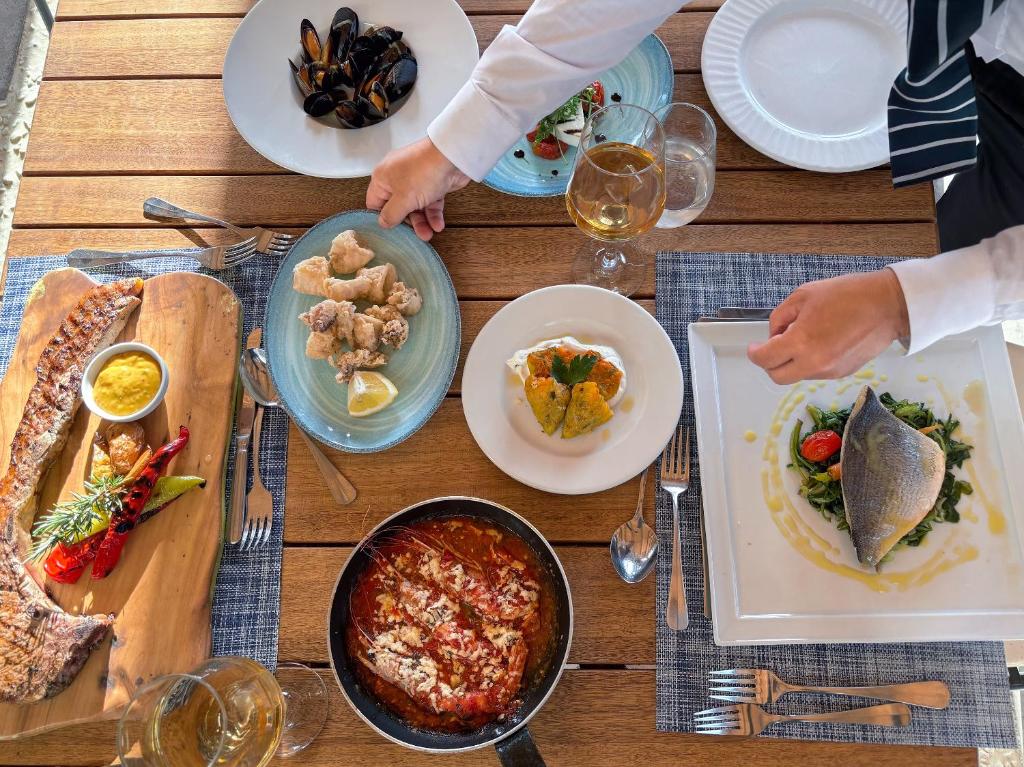 Grecotel Marine Palace & Aqua Park gourmet dining experience with seafood and meat dishes.