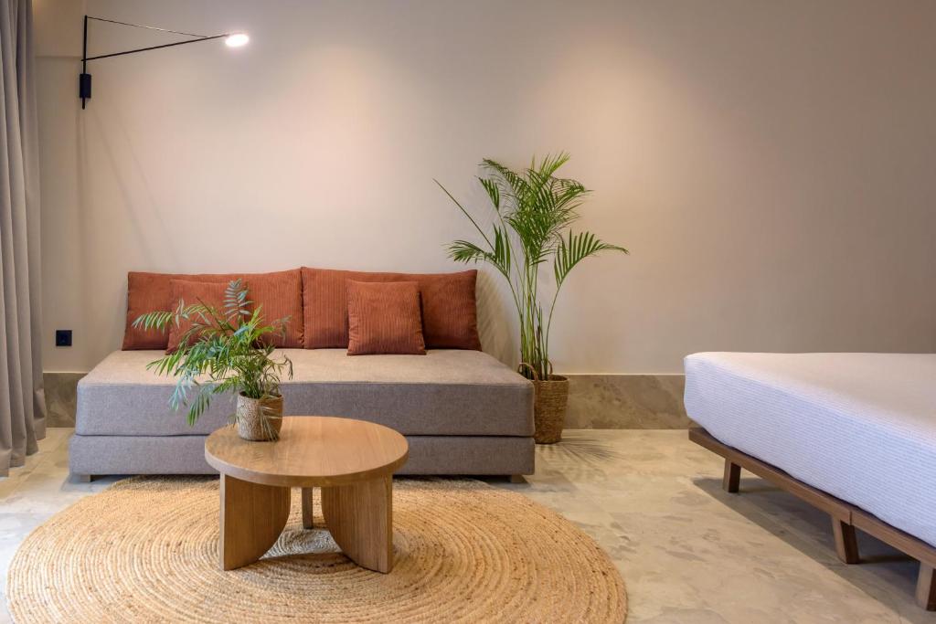 Mūsdienīgs INNSiDE by Meliá Elounda numura interjers ar ērtu atpūtas stūrīti un dabas elementiem