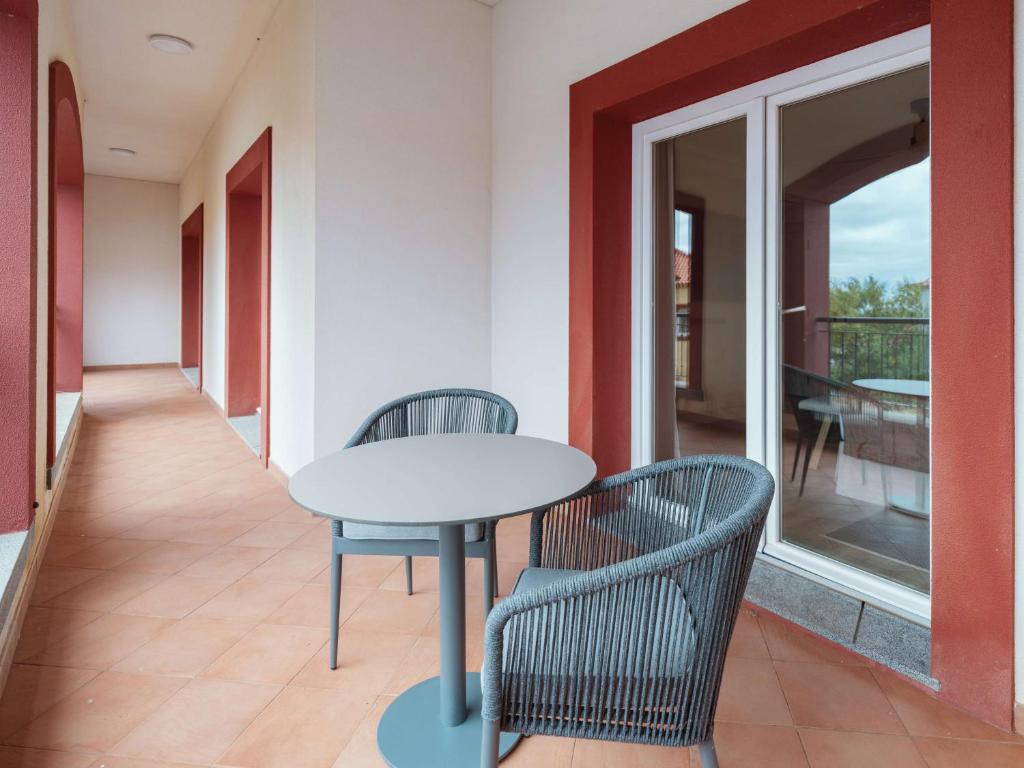 Terrace at Dreams Madeira Resort Spa & Marina with chairs and table.