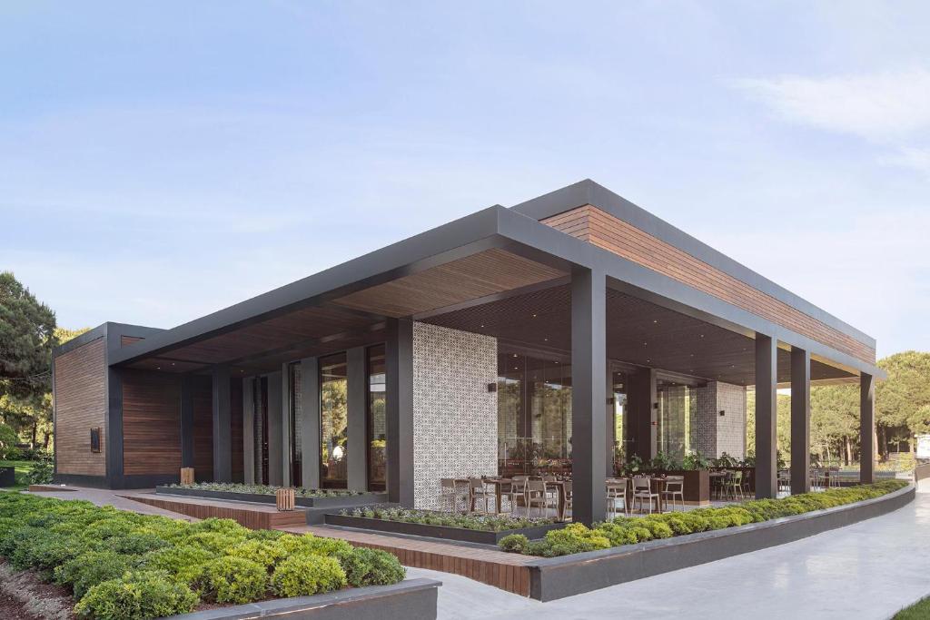 Moderns restorāns pie Voyage Belek Golf & Spa ar terasi un dārzu