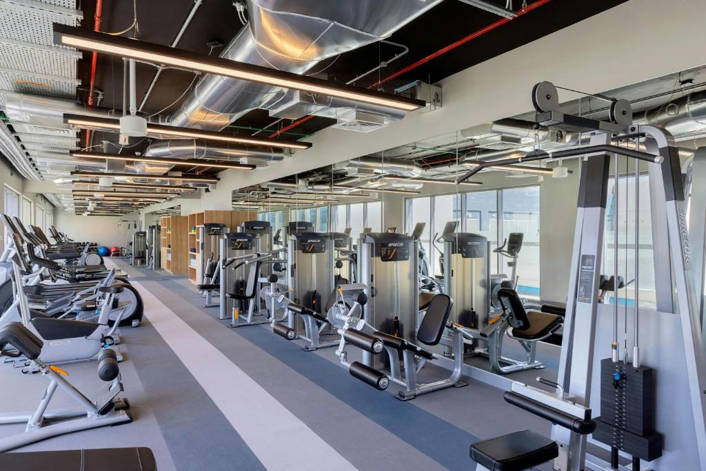 Aloft Al Mina modern fitness center with gym equipment.
