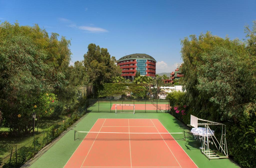 Tennis courts surrounded by greenery at Delphin Deluxe.