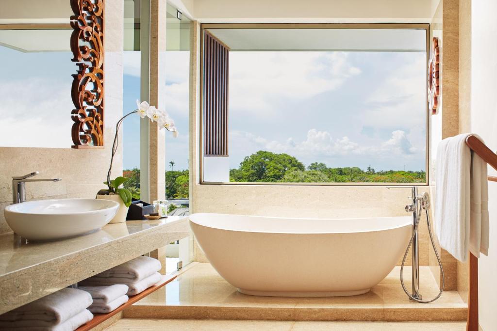 Moderns vannas istabas interjers ar brīnišķīgu skatu uz dabu. Gaismas toņos veidota vanna un elegantas sīkas detaļas rada relaksējošu atmosfēru.