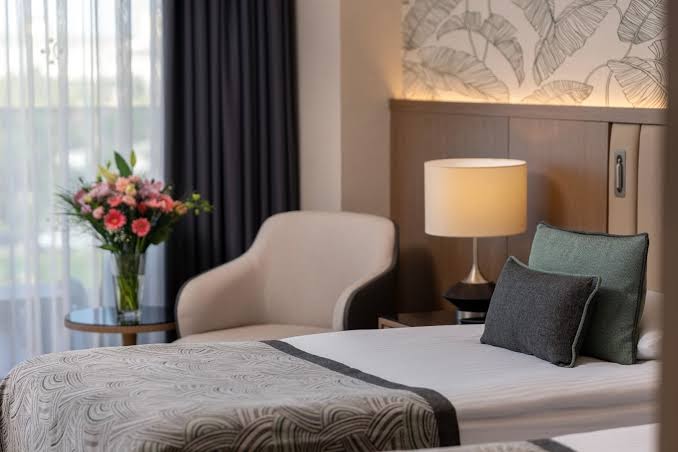 Miracle Resort Hotel numura atpūtas zona ar ērtu atpūtas krēslu, ziedu pušķi un modernu apgaismojumu.