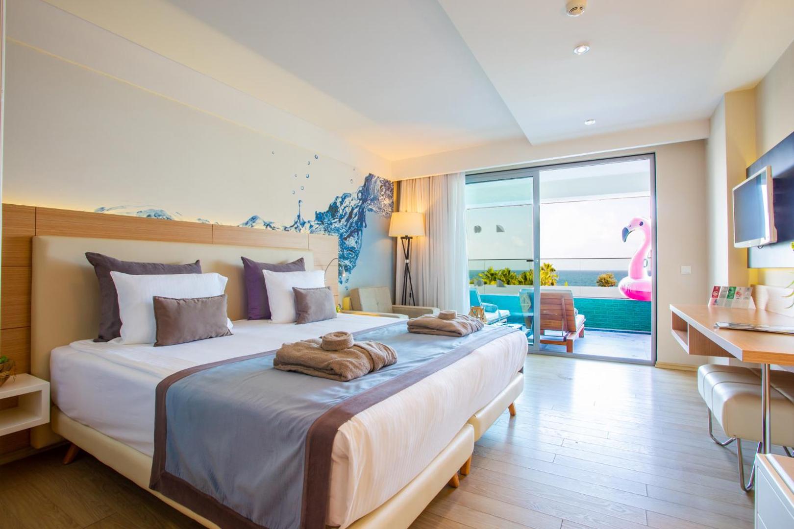 Selene Beach and Spa Hotel moderns numurs ar balkonu, no kura paveras skats uz jūru — gaišs interjers un stilīgs dizains