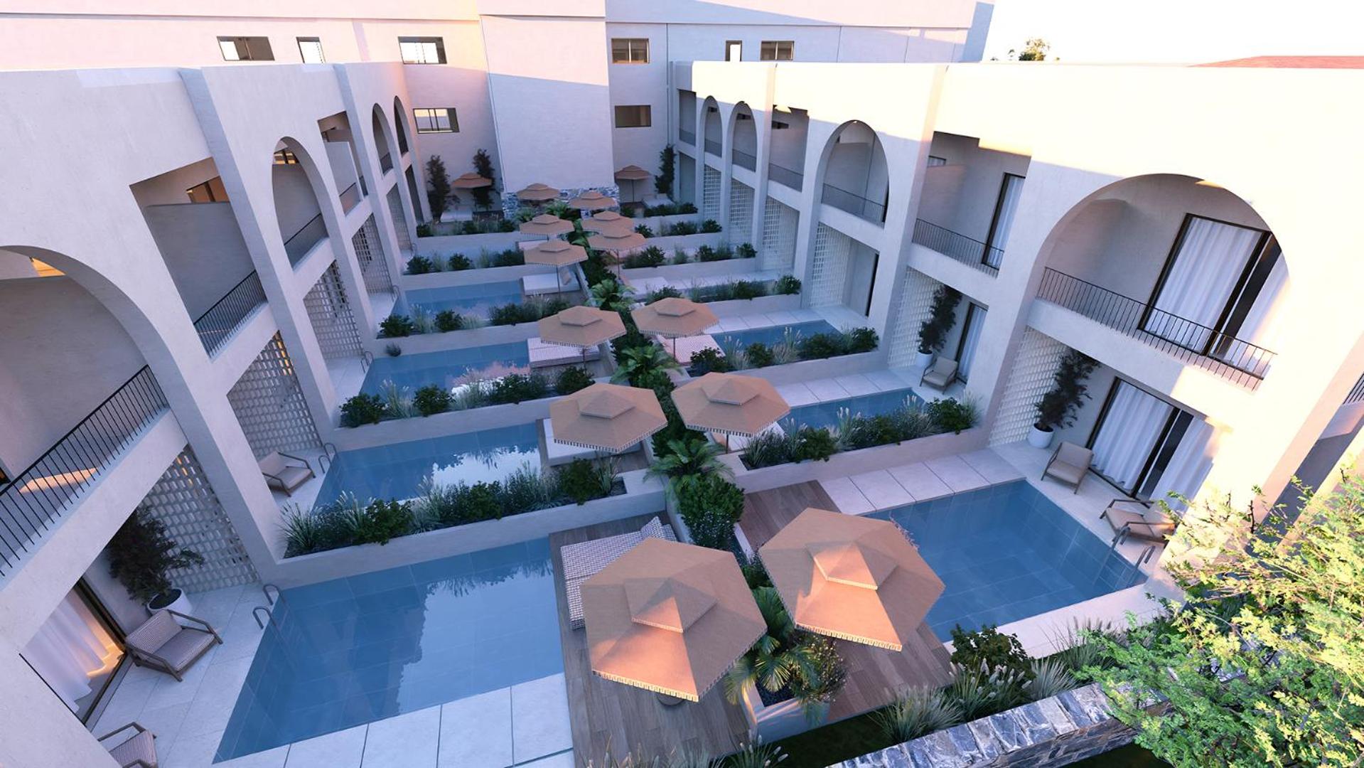 Vasia Resort & Spa numuri ar tiešu piekļuvi baseinam — privātas terases ar saulessargiem un koplietošanas baseinu joslām starp ēkām