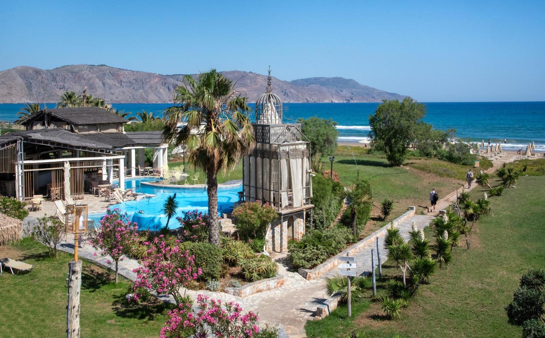 Orpheas Resort Hotel skats uz baseinu un jūras piekrasti Georgiupoles reģionā, Krētā — zils ūdens un kalnu fons