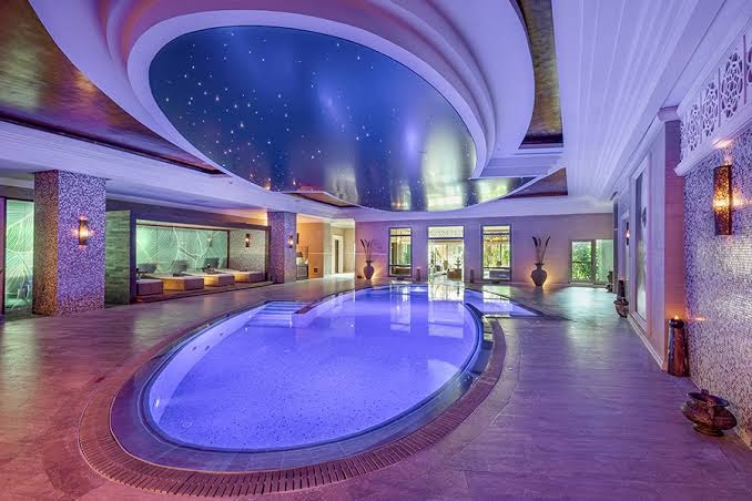 Ela Excellence Resort Belek greznais iekštelpu spa baseins ar zvaigžņotas debess griestu dekoru un mīkstiem atpūtas krēsliem fonā