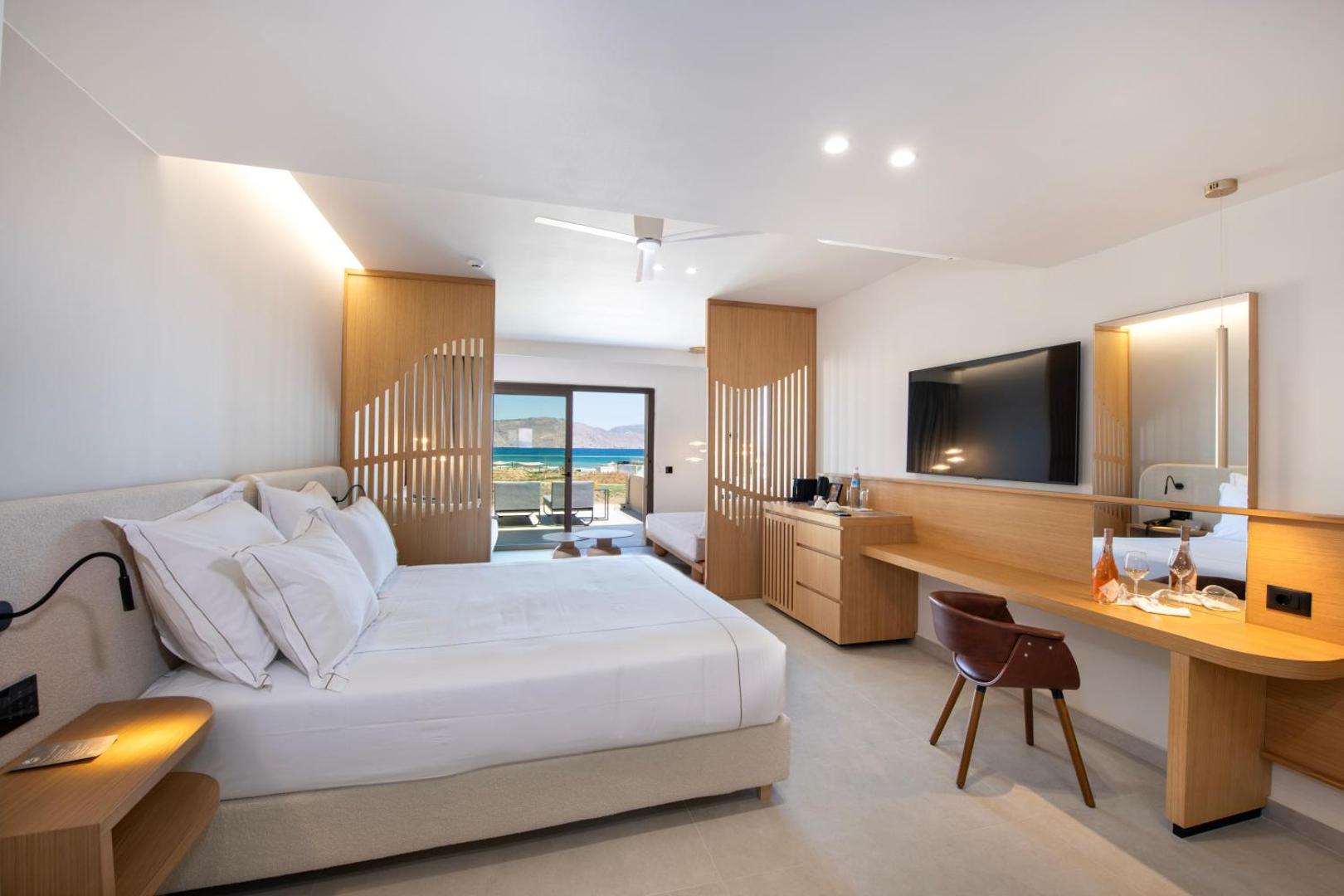 Ventale Island Breeze Resort luksusa numura interjers ar darba zonu, TV un skatu uz jūru caur balkonu
