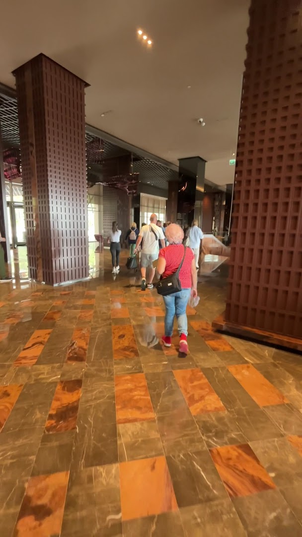 Lusso Sorgun viesnīcas lobby zona ar marmora grīdu, masīvām kolonnām un viesiem, kas dodas uz saviem numuriem Sorgunā