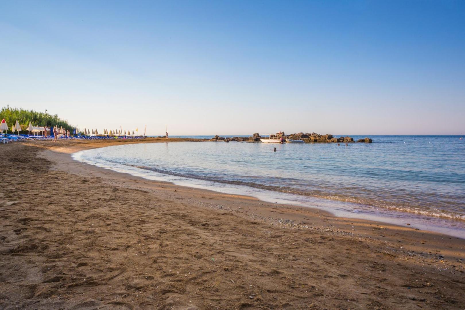Lonicera Resort & Spa Hotel privātā smilšu pludmale ar lēzenu ieeju jūrā un nelielu akmeņu molu Alanjas reģionā
