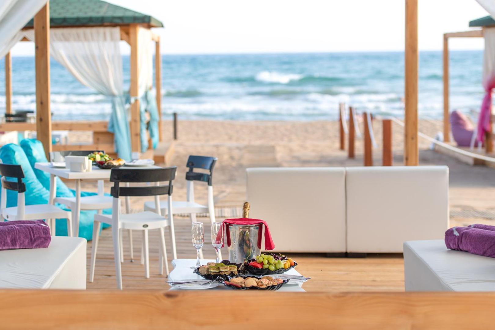 Sentido Kamelya Selin Luxury Resort & SPA uzkodas un šampanietis uz galdiņa pludmales atpūtas zonā Sidē, Turcijā