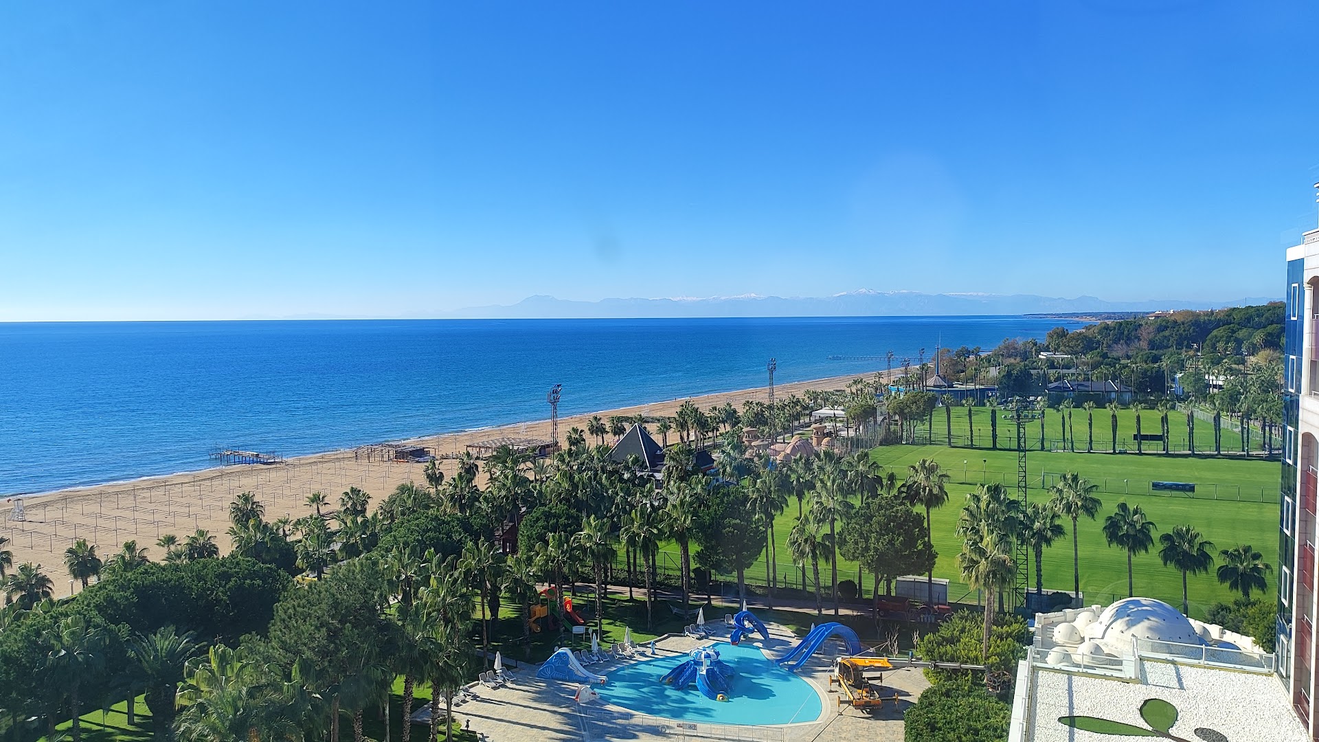 Panorāmas skats no Sentido Kamelya Selin Luxury Resort & SPA uz Vidusjūras piekrasti, smilšu pludmali un futbola laukumiem