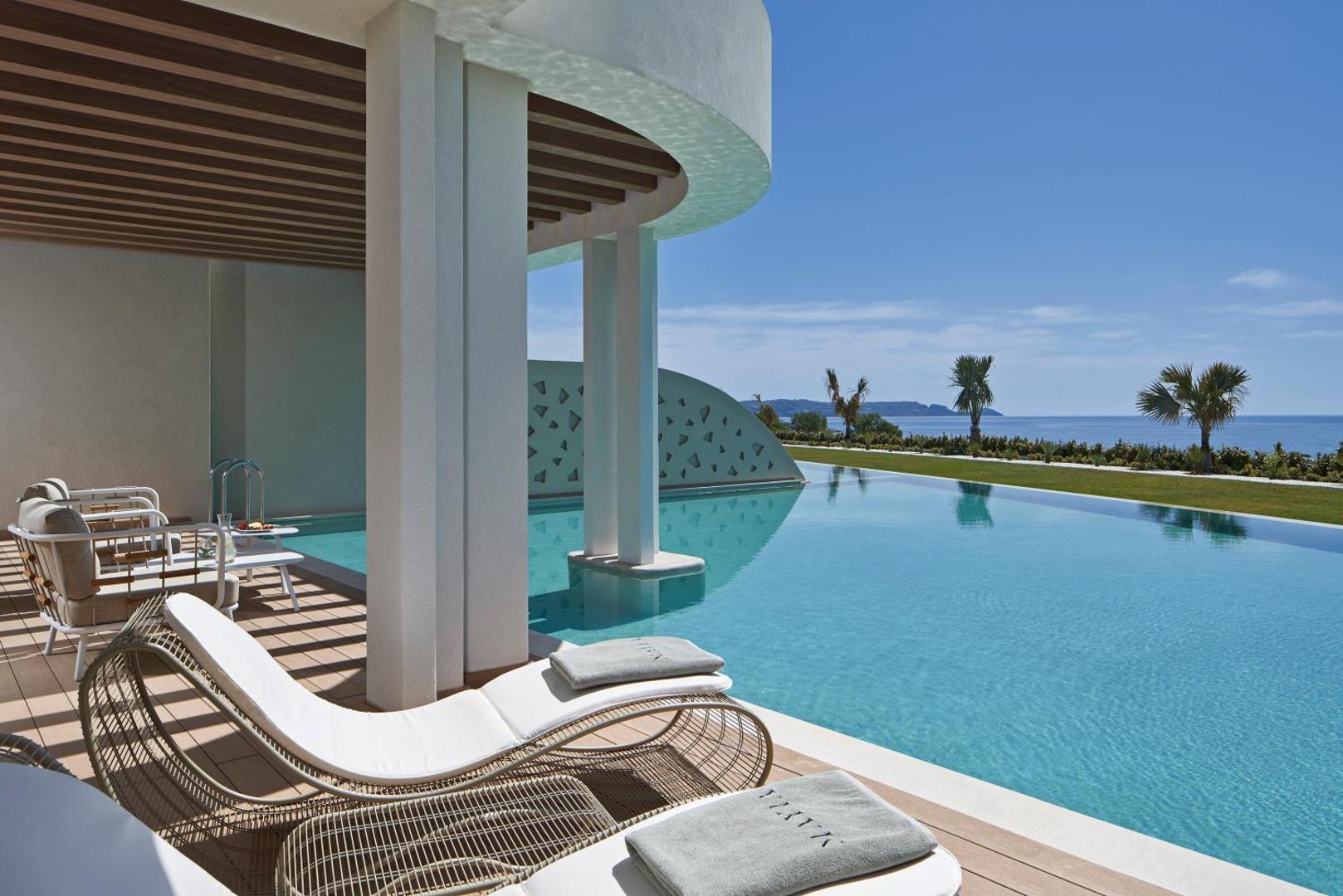 Mayia Exclusive Resort & SPA āra baseins ar pārplūdes malu un skatu uz jūru Rodā — luksusa atpūtas zona ar sauļošanās krēsliem