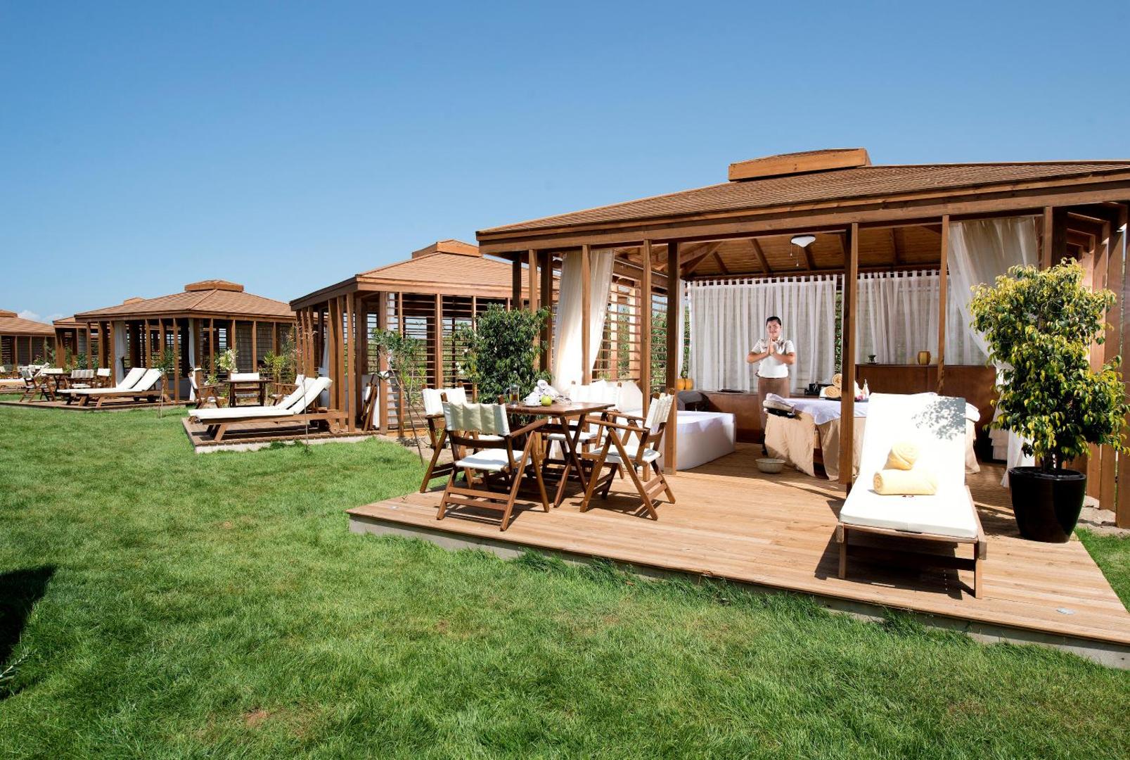 Xanadu Resort Hotel koka bungalo tipa atpūtas namiņi zālienā, kas paredzēti spa procedūrām un privātai relaksācijai