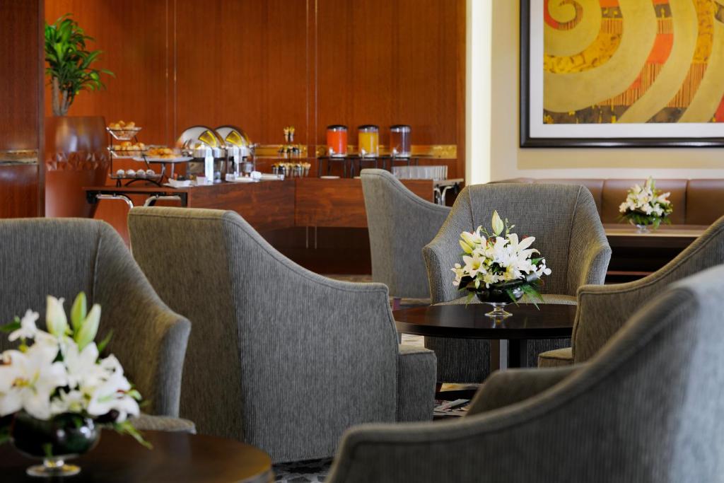 Elegant lounge at Crowne Plaza Dubai Jumeirah with floral decor.