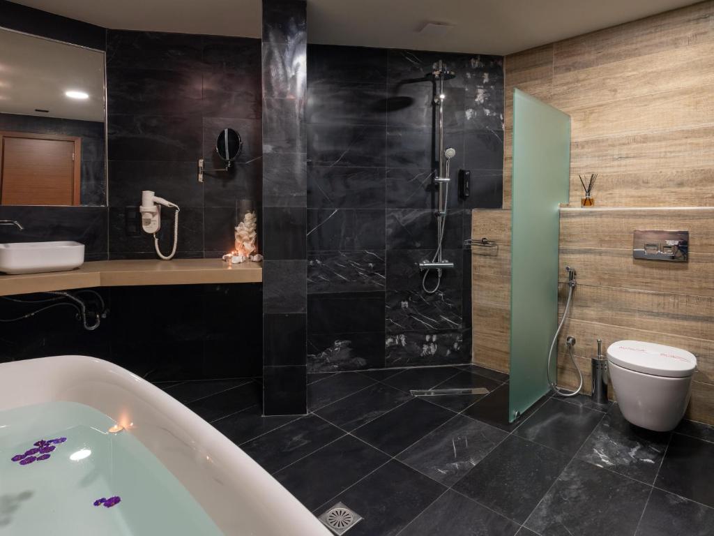 Mūsdienīga vannas istaba ar vannu un dušu Eva Mare Hotel & Suites