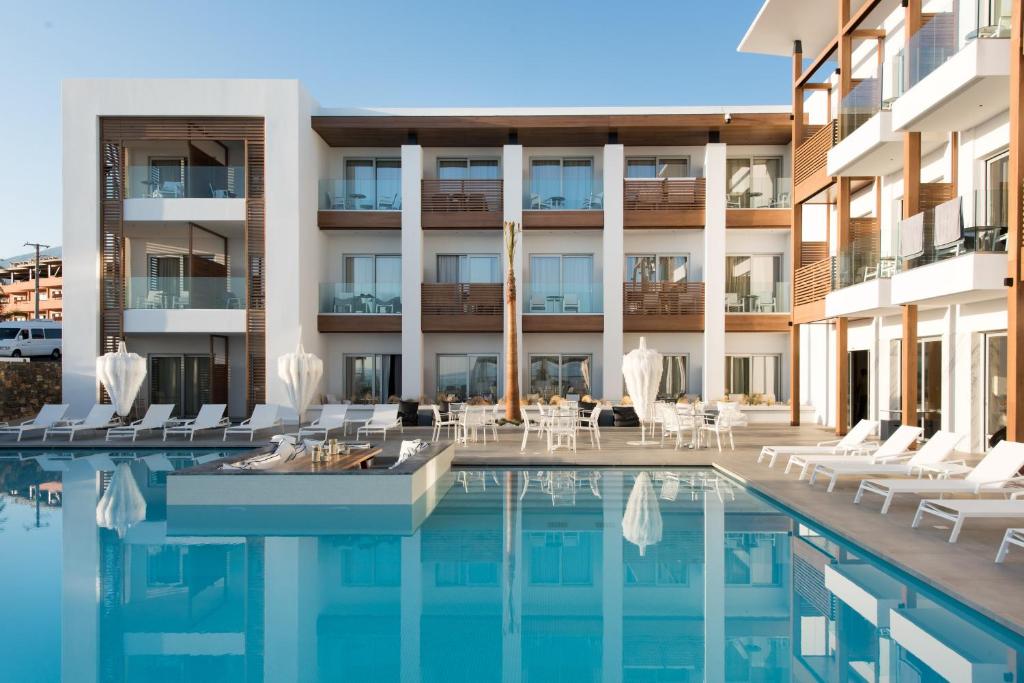 Enorme Ammos Beach Resort baseins ar saulainu ēku fonā