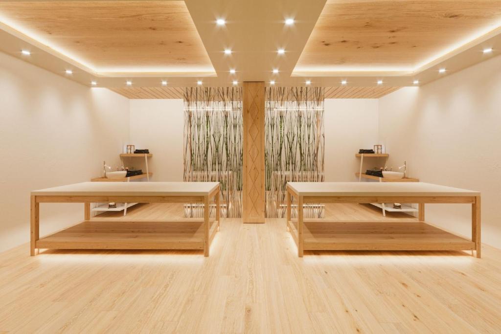 Moderns interjers ar divām koka galdiem un siltu apgaismojumu, radot relaksējošu atmosfēru. Telpa ietver dabīgu dekoru un elegantu dizainu.