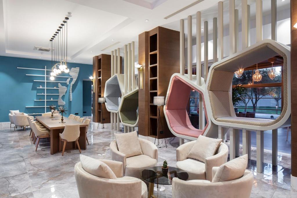 Mūsdienīgs un stilīgs viesnīcas Nirvana Cosmopolitan uzgaidāmais telpa ar ērtām mēbelēm.